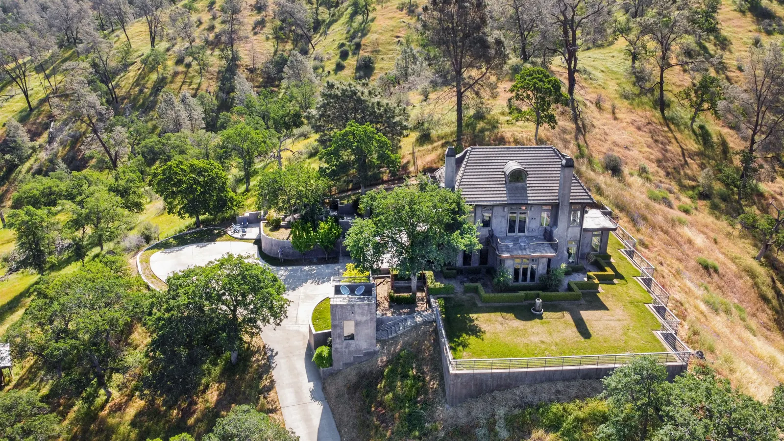 Aerial view of the gated estate and driveway among the oak foothills