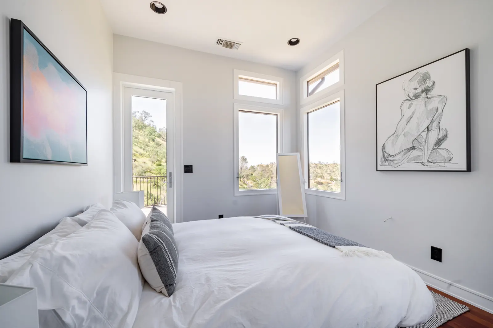 Bright bedroom with a door to a private balcony
