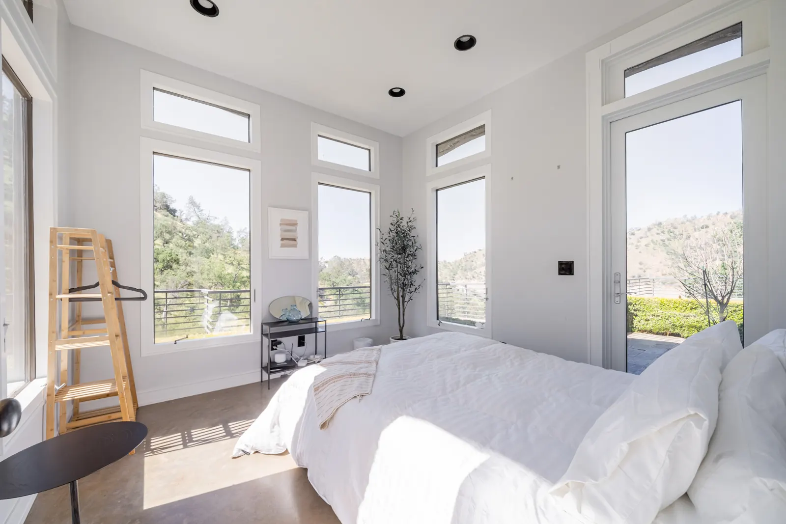 Bedroom with a queen bed and glass doors to the garden