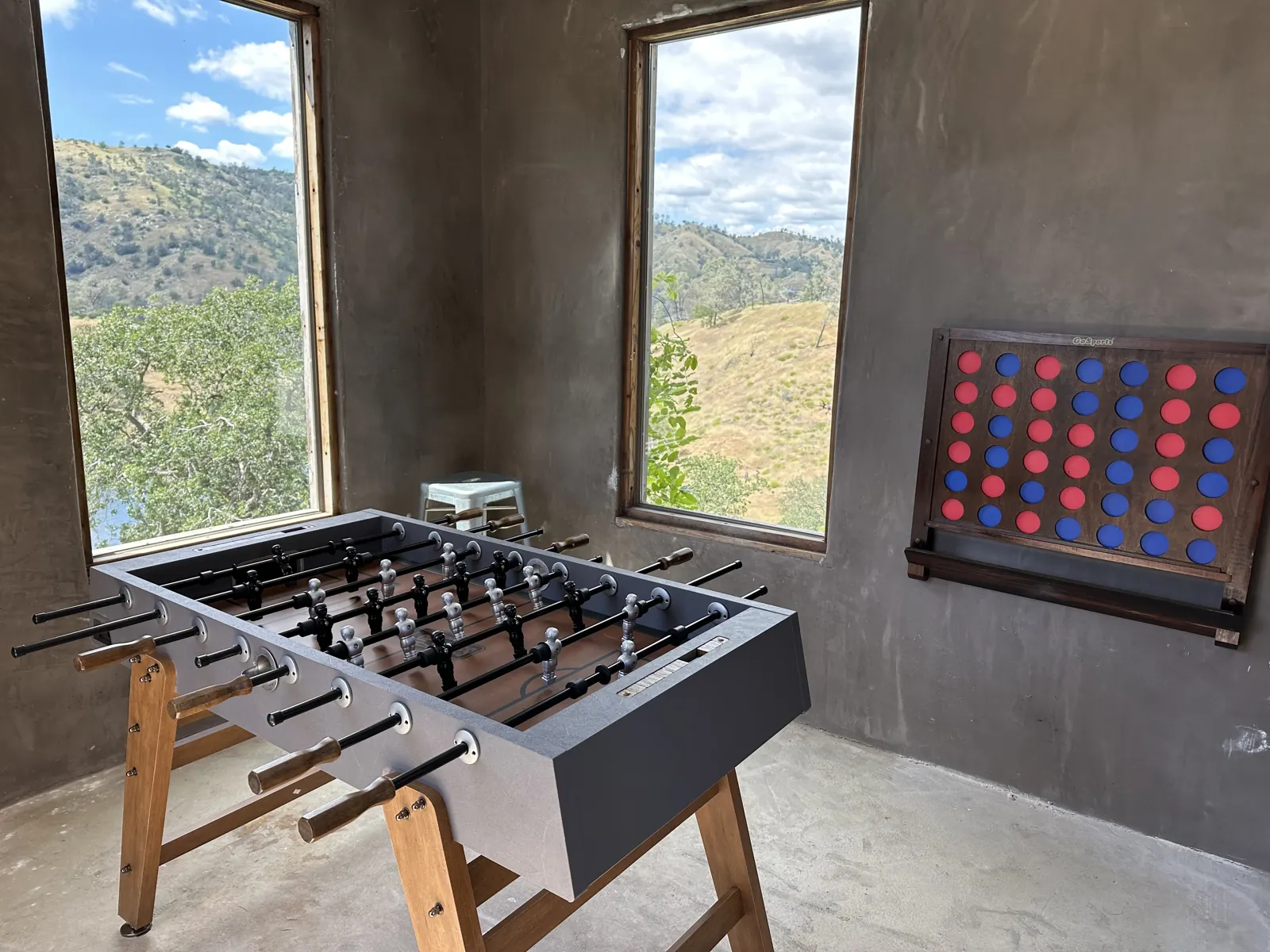 Foosball table and wall game in the small building beside the house, with lake views
