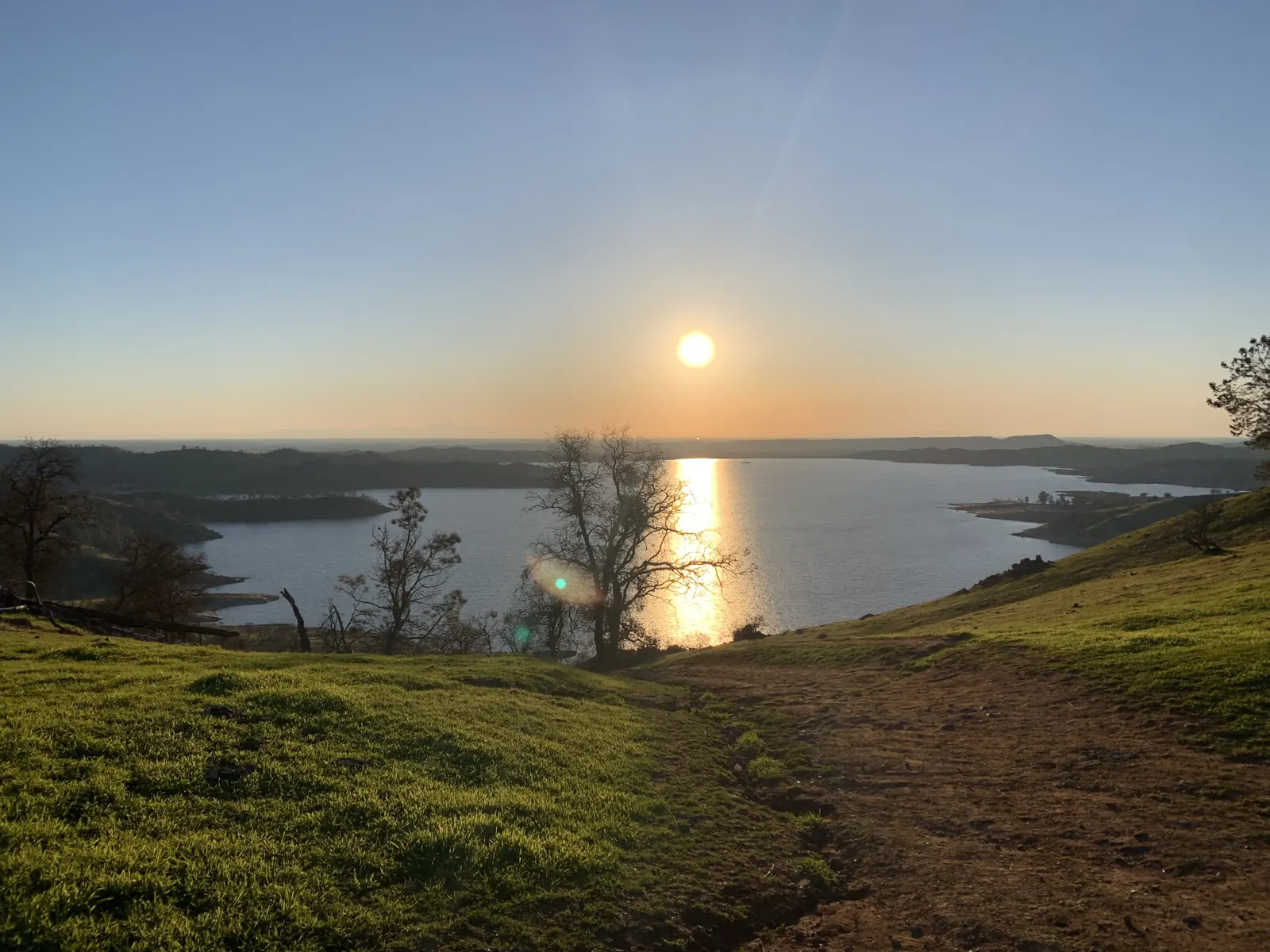 Sunrise over Millerton Lake from a grassy hillside near the villa